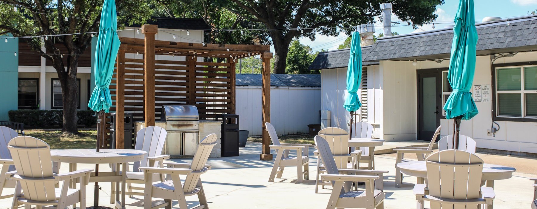 a patio with tables and chairs
